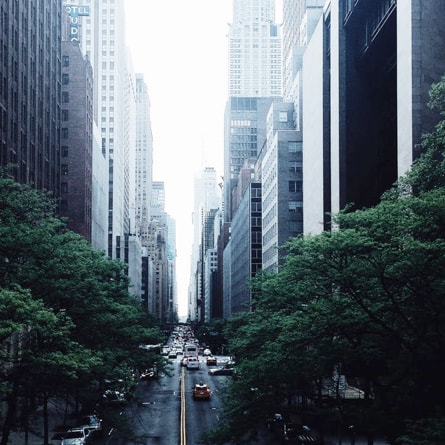 view down long city street with tall buildings