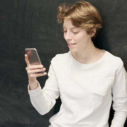 woman looking at her phone with a smile